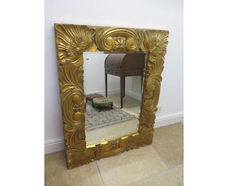 A modern ornate gilt mirror - 112cm x 87cm - in good condition 