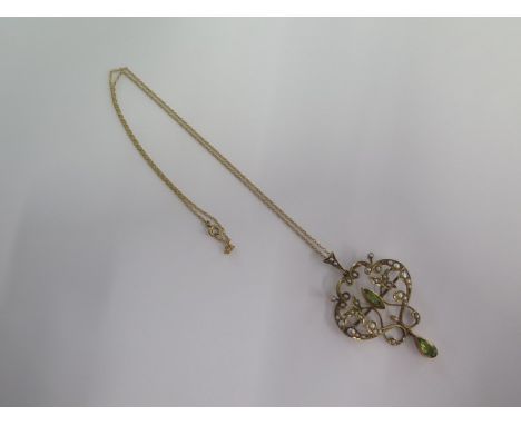 A 9ct yellow gold pearl and peridot pendant - Height 5cm - on a 9ct fine chain - total weight approx 6.2 grams 