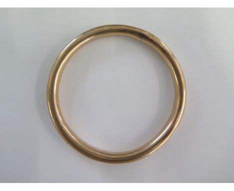 A 9ct gold hollow bangle - 8.5cm external - approx weight 18.4 grams - some dents and repairs 