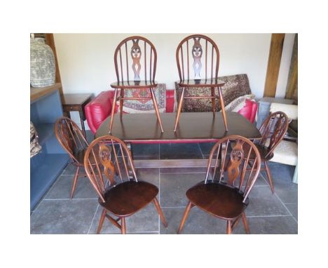 A vintage Ercol dining table and six matching chairs - 150cm x 75cm 