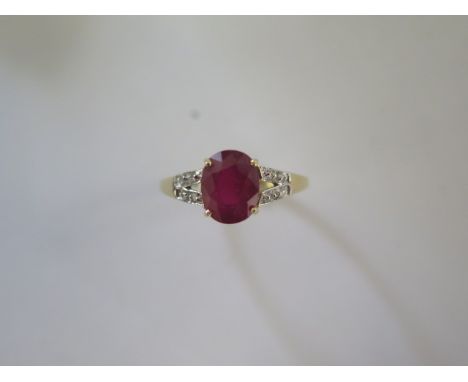 A 9ct yellow gold ruby and diamond ring, head size approx 16mm x 9mm - ring size approx R - In good condition 