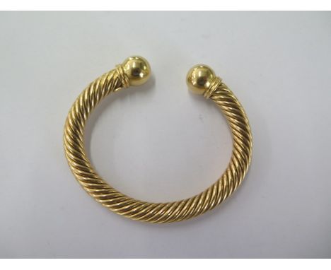 An 18ct 750 yellow gold rope twist torque bangle - approx weight 46 grams - in good condition 