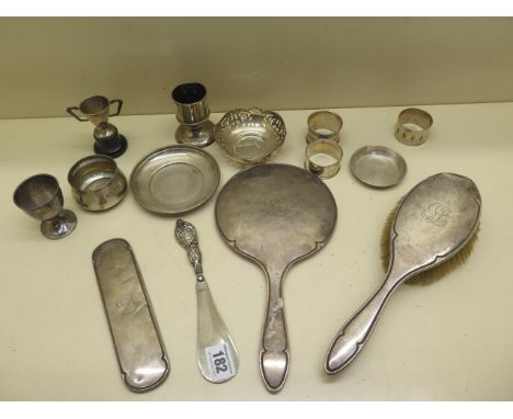 A collection of silver items including serviette rings, silver back brush and mirror etc - total weighable silver approx 7.5 