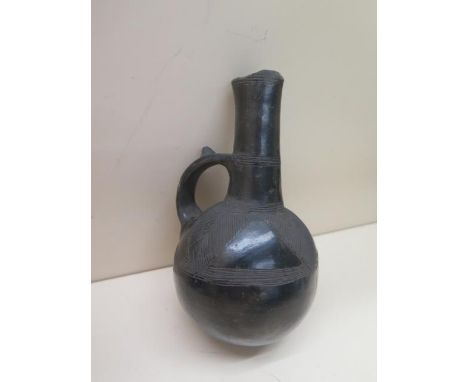 A Pre-Columbian or later black ware flask with leaf decoration, 17cm tall damage to top and a polychrome vessel decorated wit