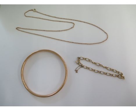 A 9ct yellow gold 58cm necklace, a 9ct bracelet and a hollow 9ct bangle - some dents to bangle but generally good - total wei