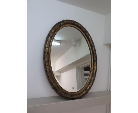 An oval gilt mirror - 89cm x 63cm 