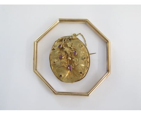 A gold plated octagonal bangle - 8cm wide external - and a gilt metal mourning brooch 