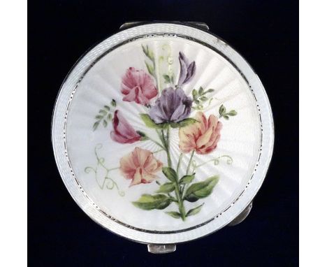 A silver circular compact, the lid enamelled with sweet peas on a cream guilloche enamel ground, marked for Turner &amp; Simp