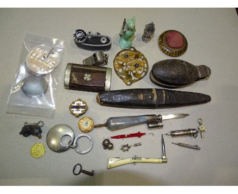 A Mauchline ware circular pin cushion, 5.5cm diameter, a wood and plated snuff box, 7cm long, an Acme whistle and miscellaneo