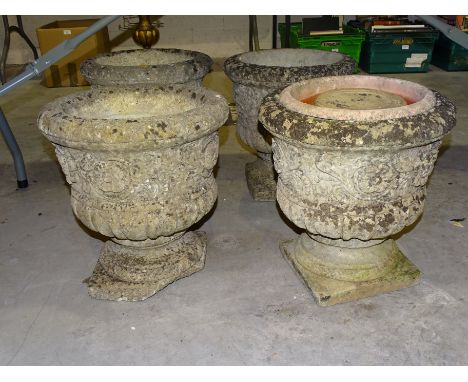 A set of four cast concrete campana-shaped garden planters,&nbsp;37cm diameter, 39cm high (one with damaged base), (4). 