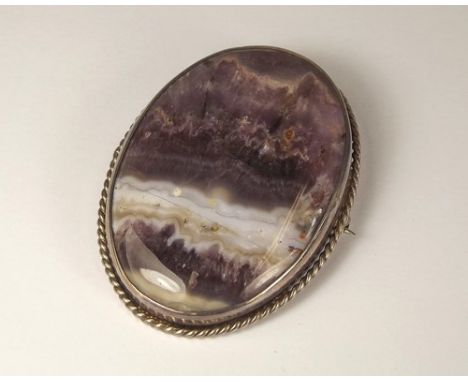 AMETHYST BROOCH.
A large polished amethyst quartz brooch, in silver mount.
5.5 x 4cm.