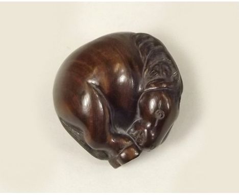 NETSUKE.
A Japanese carved hardwood, sleeping horse netsuke, signed.
