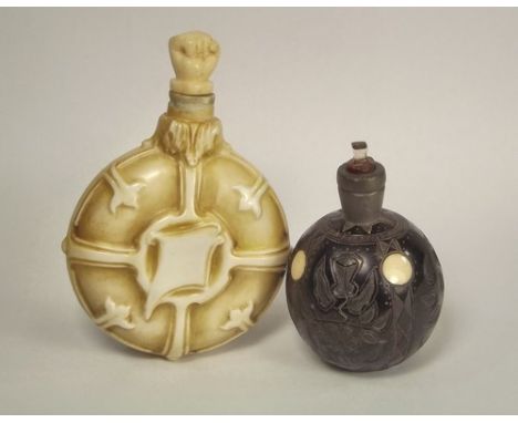 SCENT BOTTLES.
A pewter mounted, bone inlaid carved wood scent bottle & a ceramic scent flask, with matched carved hand bone 