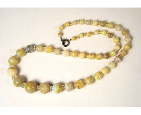 OPAL NECKLACE. 
An opal necklace comprising 47 graduated beads with crystal spacer beads. Smallest bead 3mm. approx, largest 