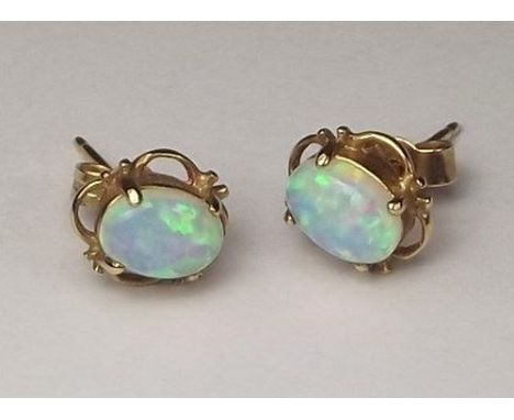 EARRINGS. 
A pair of 9ct. gold mounted, synthetic opal ear studs. 