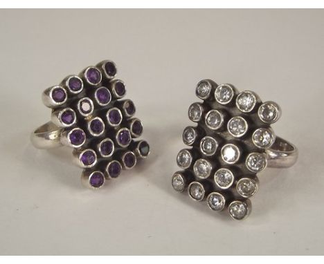 DRESS RINGS.
Two silver dress rings, one set amethyst, the other clear paste. 2 x 1.5cm.