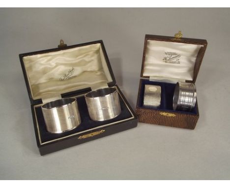 NAPKIN RINGS.
A pair of Art Deco, engine turned napkin rings, cased, Sheffield 1933 & two other napkin rings.