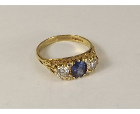 SAPPHIRE & DIAMOND RING.
A 1980's, Victorian style, 18ct. gold, cornflower blue sapphire & diamond ring. Size O/P.