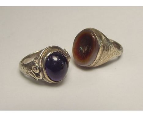 SILVER RINGS.
Two hand made silver rings by John (Red) Simpson, St. Ives, one set with onyx, the other with amethyst.