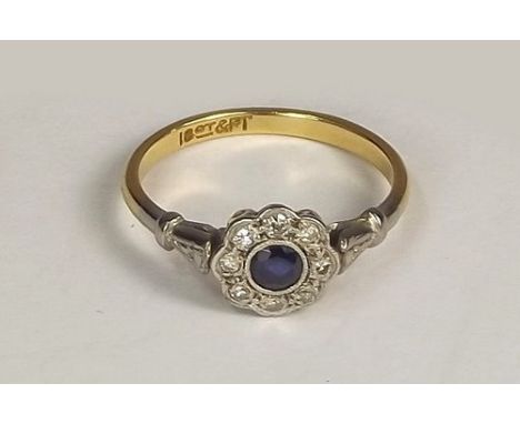 SAPPHIRE RING.
An 18ct. gold & platinum, sapphire & diamond cluster ring. Size M.