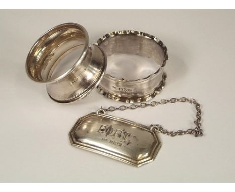 NAPKIN RINGS ETC.
Two silver napkin rings & a modern silver Port spirit label.
