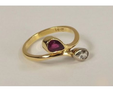 CROSS-OVER RING.
An 18ct. gold cross-over ring, set with a navette cut ruby & diamond. Size L.