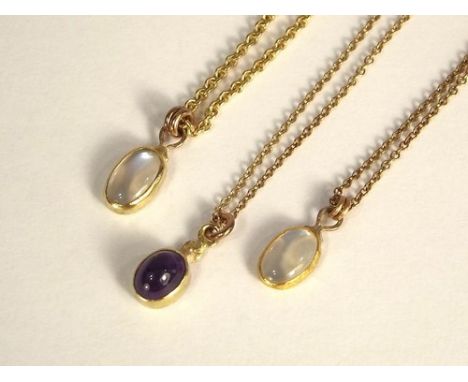 GOLD PENDANTS.
Two moonstone & one amethyst pendant, in hand made gold settings & on 9ct. gold chains.