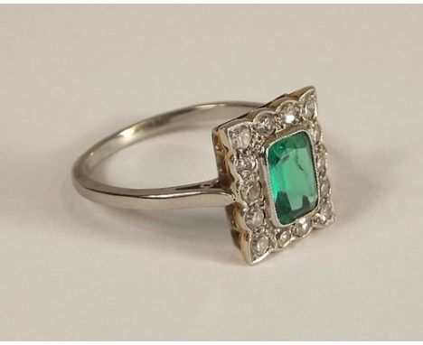 DIAMOND & EMERALD RING.
An 18ct. gold & platinum, emerald & diamond ring. The emerald 7 x 5mm. Size Q.