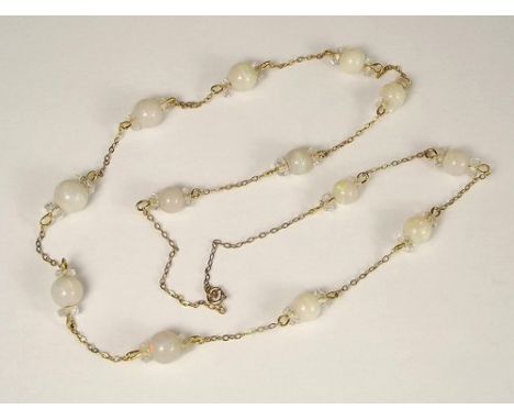 OPAL NECKLACE.
An Edwardian, graduated 13-bead, opal & crystal bead necklace, suspended on a 9ct. gold trace chain.