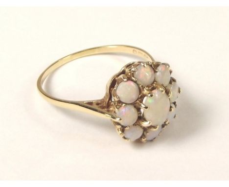 OPAL RING.
A 9ct. gold mounted opal cluster ring. 
Size W/X.