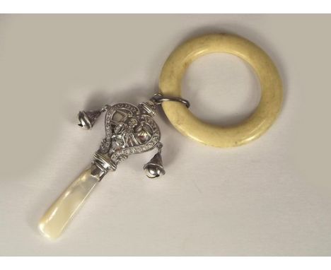 SILVER RATTLE.
A silver "Little Jack Horner" rattle, with mother of pearl teething stick & celluloid ring. Glasgow 1928.