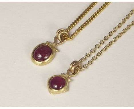 GOLD PENDANTS.
Two hand made, ruby set pendants on 9ct. gold chain.