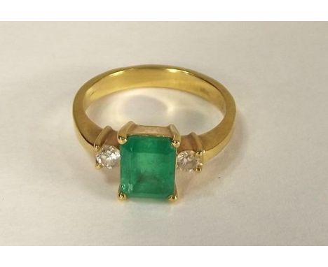 EMERALD RING.
An 18k. emerald & diamond ring. Size L.