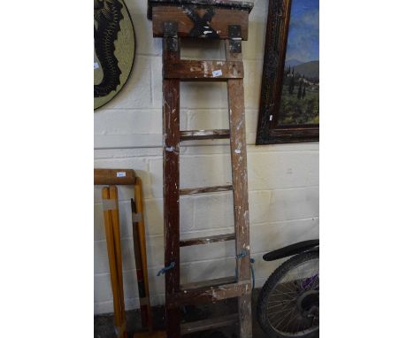 A folding wooden step ladder