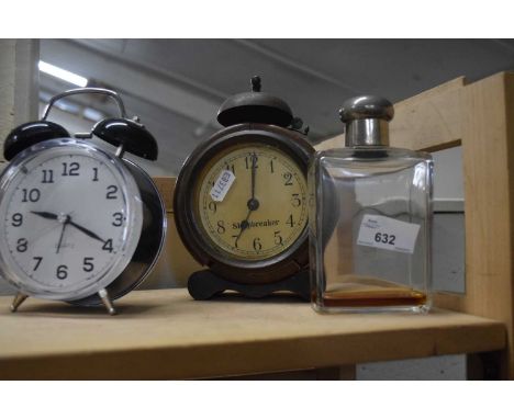 Two alarm clocks and a vintage scent bottle