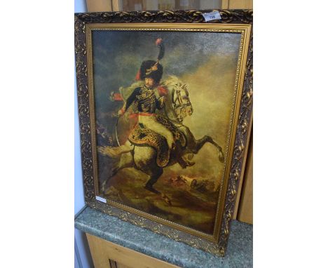 Reproduction print of an officer on horseback during battle in gilt frame