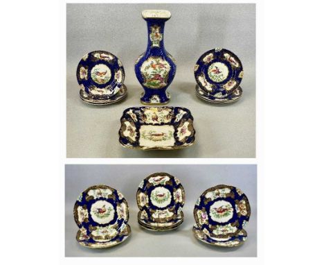 BOOTHS TABLEWARE, blue fish scale pattern with gilded highlights and panels depicting exotic birds, eight circular dishes, 23