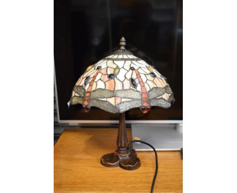 Modern bronzed table lamp with a stained and leaded glass style shade having dragonfly decoration   Condition: 