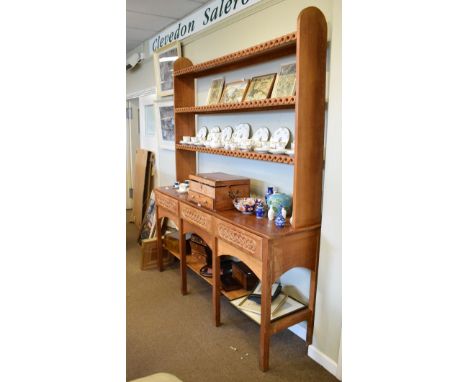 Mid 20th Century oak dresser, the base fitted three carved Celtic knot design drawer fronts above a pot board, with a plate r
