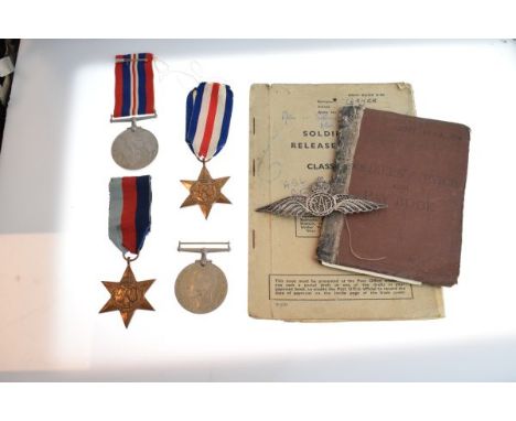 Four World War II medals, filigree white metal R.A.F. brooch, army release book and service/pay book   Condition: 