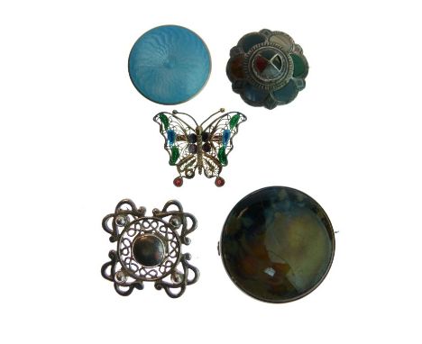 White metal and blue enamel decorated circular brooch, Scottish hardstone brooch and one other Celtic design silver brooch, a