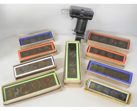 Eleven boxes of late 19th century Bilder lantern slides, amusing and macabre scenes, each box contains approximately twelve s