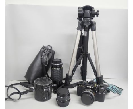A Minolta X-700 35mm film camera with 50mm lens. With two other lenses, 28mm and 80-205mm and tripod