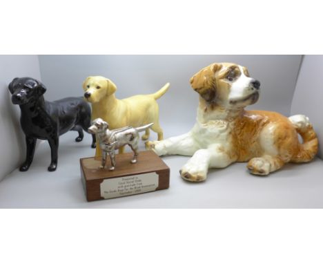 Two Beswick model labradors, black and golden, a large Goebel model of a puppy and a Guide Dogs for the Blind presentation mo