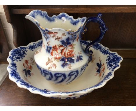 A jug and wash basin set with matching vase with blue and gilt floral decoration.