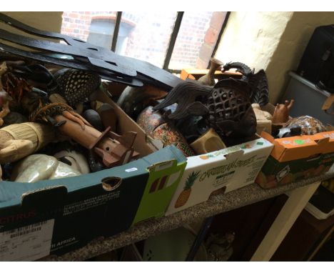 Three crates of various items including wooden and ceramic sculptures, masks, a vase etc.