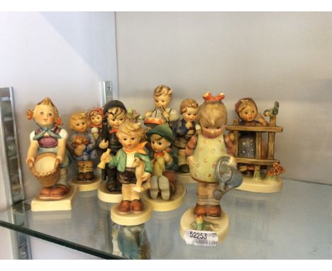 Eleven Goebel Hummel children figurines.