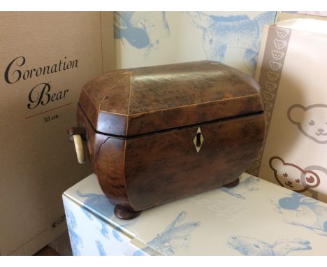 A georgian walnut dome topped tea caddy with Ivory ring handles and bun feet.