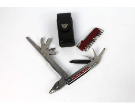 A Victorinox Swiss tool multi tool, with leather pouch, screwdriver etc.