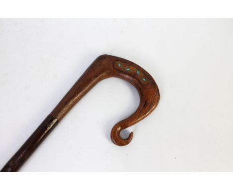 A walking stick with wooden handle with Celtic inspired decoration.  Height 136 cm.